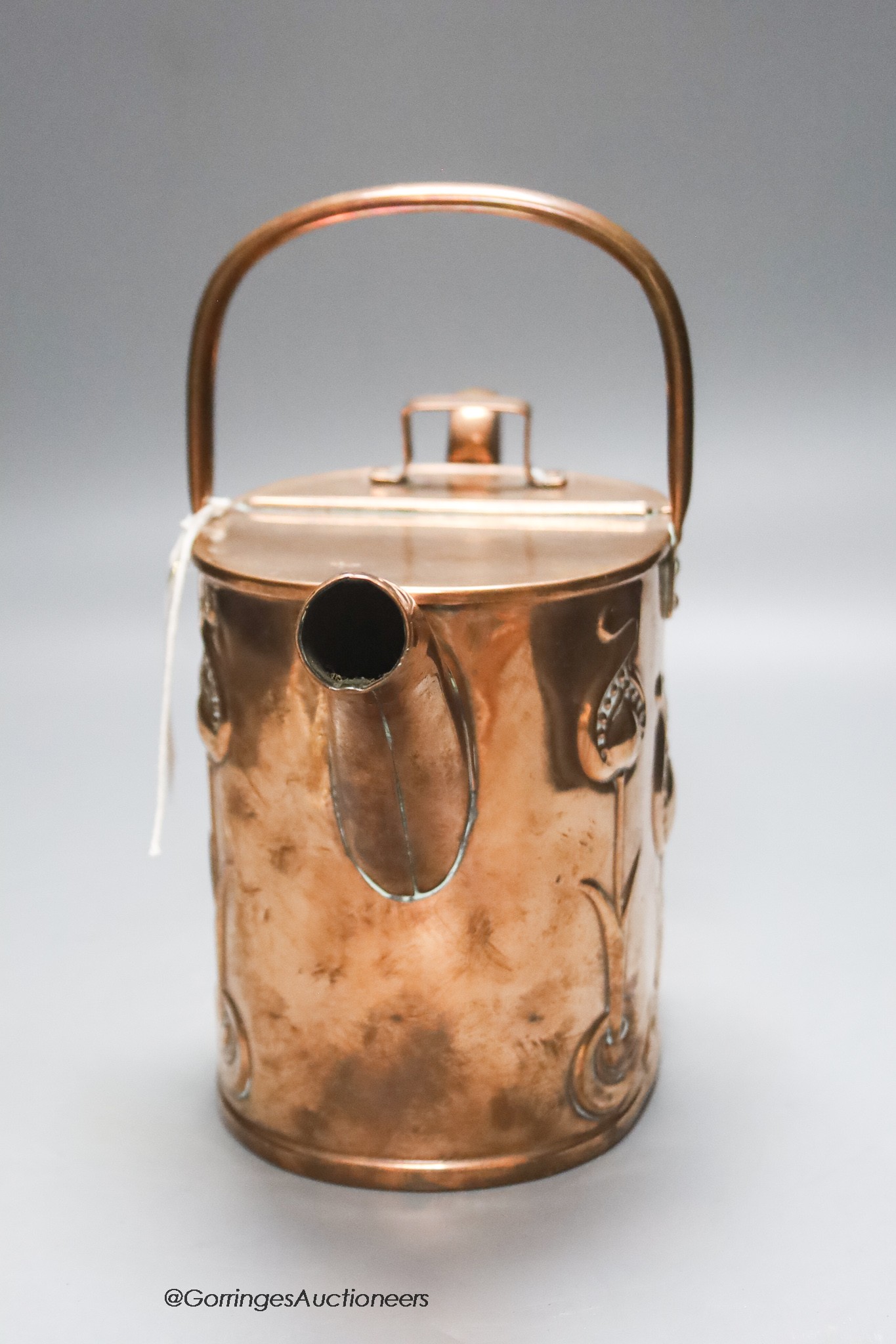 An Art Nouveau Joseph Sankey embossed copper water can, height 22cm